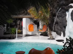 Interior view of César Manrique's foundation in Lanzarote with white walls, pool and volcanic rock.